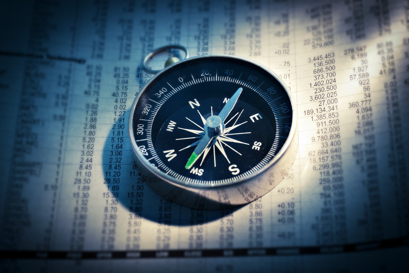 Compass on a sheet of financial figures
